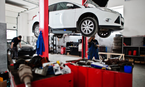 Car repair and maintenance theme. Mechanic in uniform working in auto service.