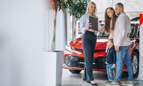Family with son choosing a car in a car showroom Family with son choosing a car in a car showroom